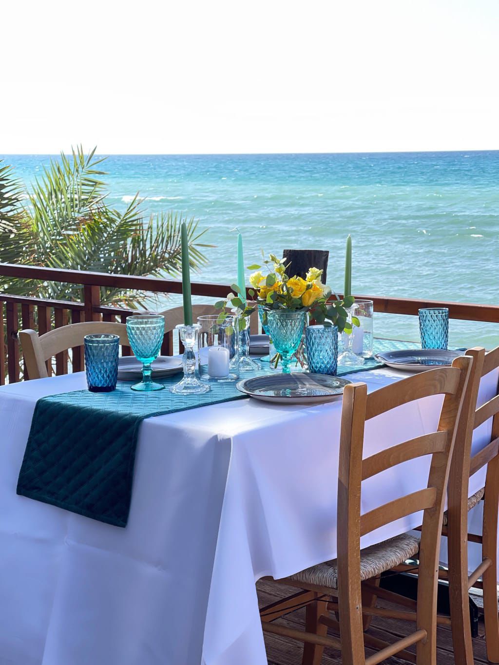 A dressed table looking out onto the blue Mediterranean