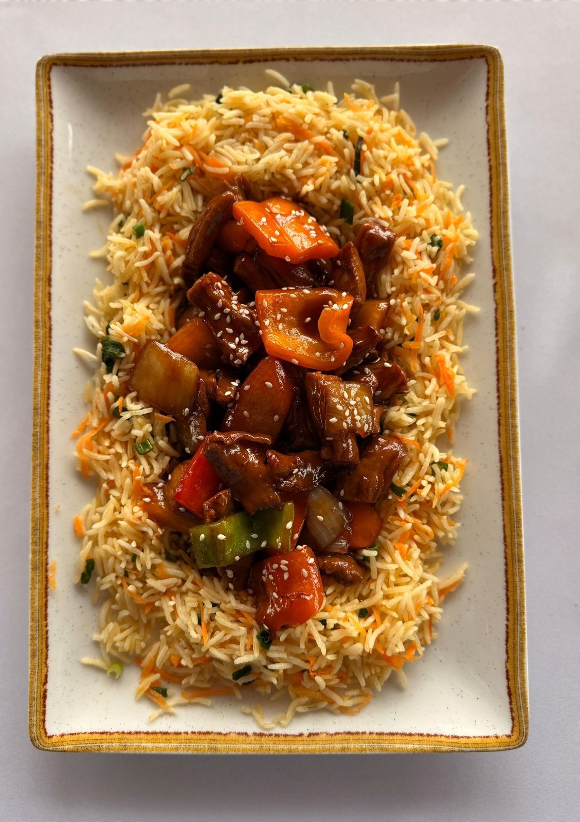 A generous platter of rice, vegetables and glazed meat