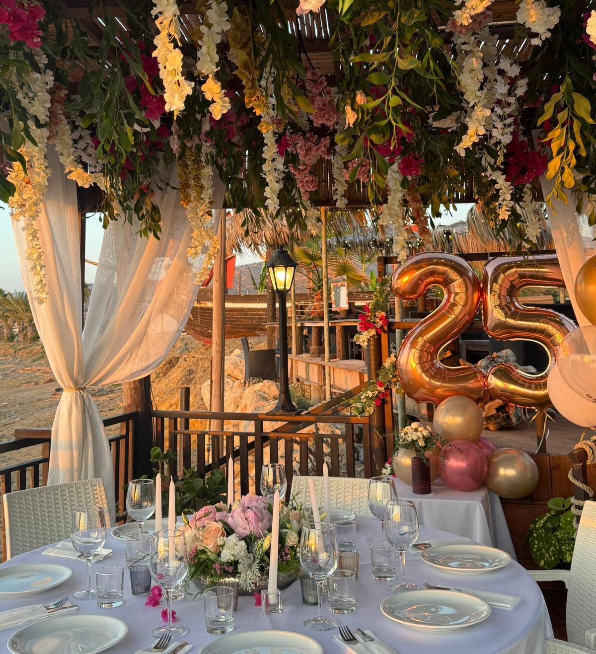 Flower-decorated celebration tables at sunset